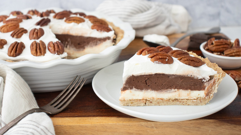 Side shot of a possum pie slice with whole pie in the background