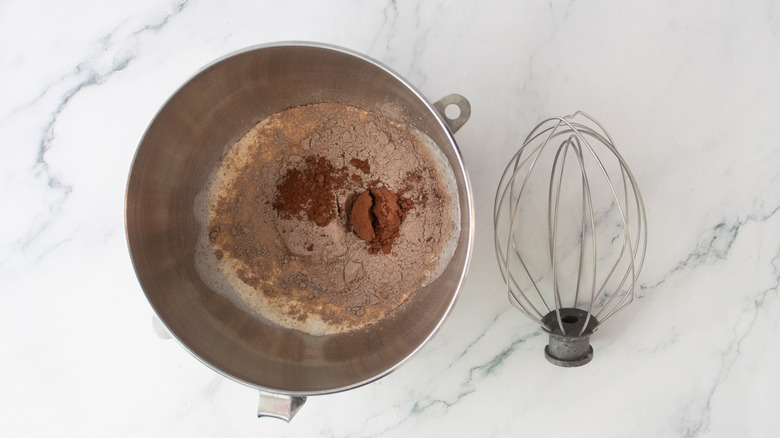 Chocolate filling ingredients in a stand mixer bowl with whisk