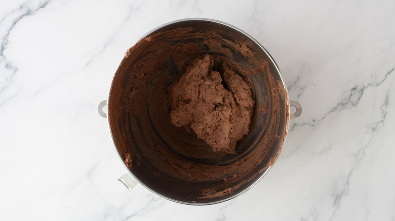 Thick and fluffy chocolate filling in a stand mixer bowl