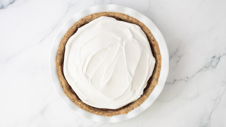 Whipped topping spread over chocolate pie