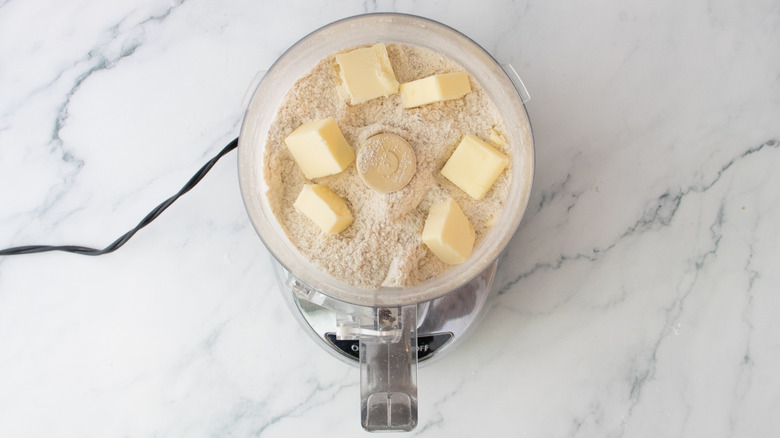 Dry flour mix and pats of butter in a food processor