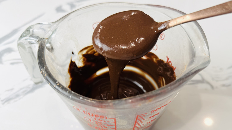 Chocolate glaze in a measuring cup