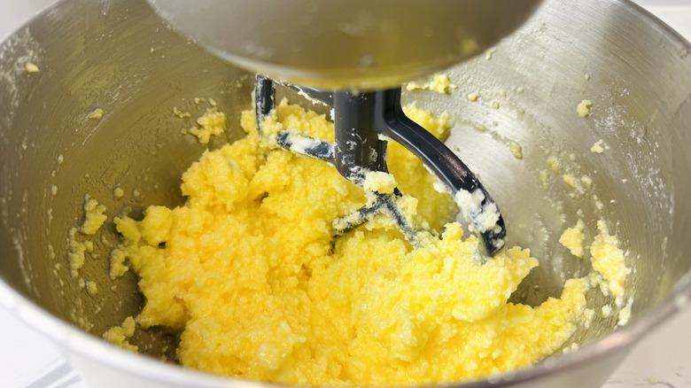 Butter, sugar, and eggs being beaten together