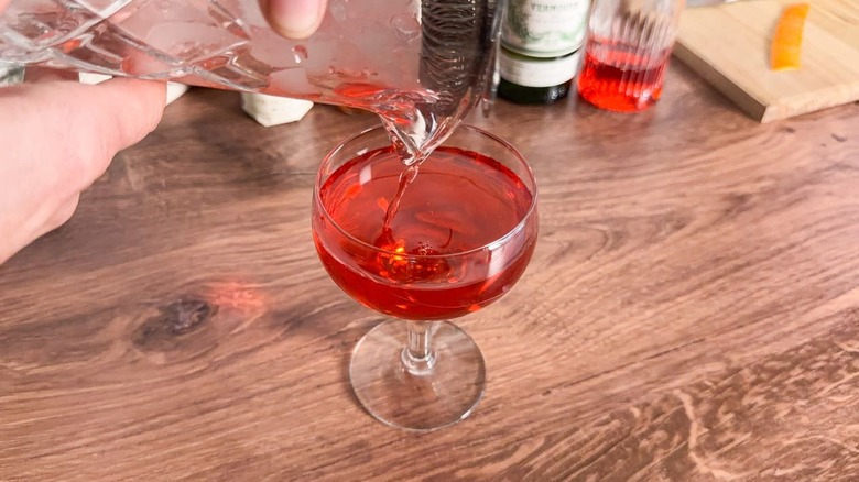 Straining Old Pal cocktail into coupe glass