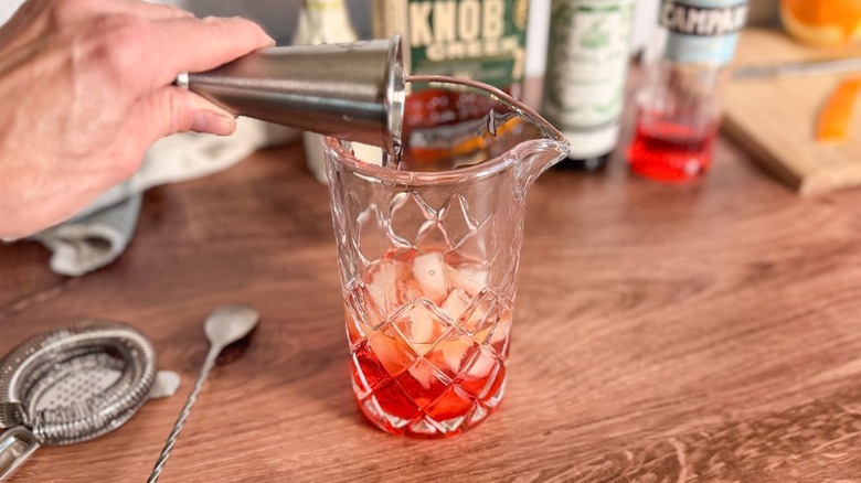 Adding vermouth to Old Pal cocktail in crystal mixing pitcher