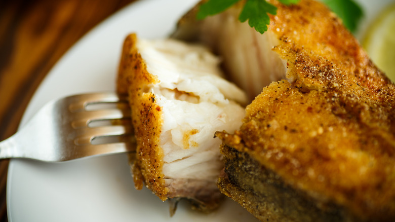 Closeup of fried catfish garnished with parsley