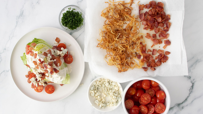 Iceberg wedge topped with tomatoes and bleu cheese