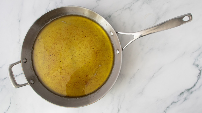 Olive oil and bacon drippings in a stainless skillet