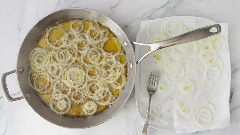 Onions frying in a large skillet