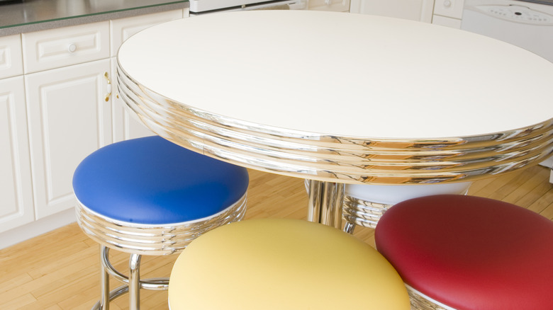 A white table with chrome detailing on edge