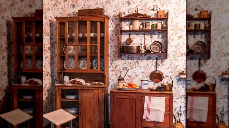 A kitchen with floral wallpaper