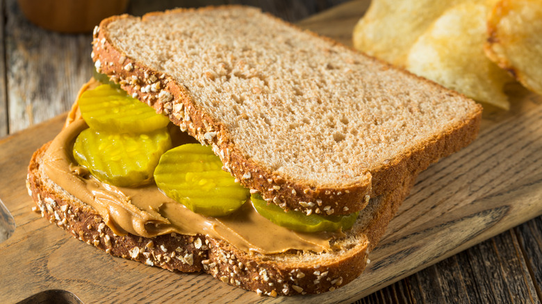 Sliced pickle chips on a peanut butter sandwich with multigrain bread