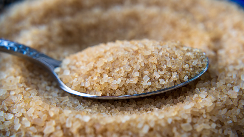 Closeup of brown sanding sugar on a spoon