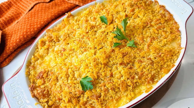 Corn casserole with cracker crumb topping in oval baking dish