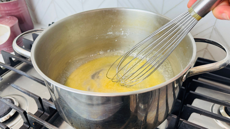 Large whisk combining flour and butter in pot