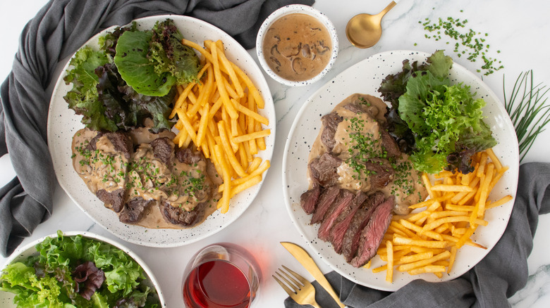 Overhead shot of Steak Diane two plates