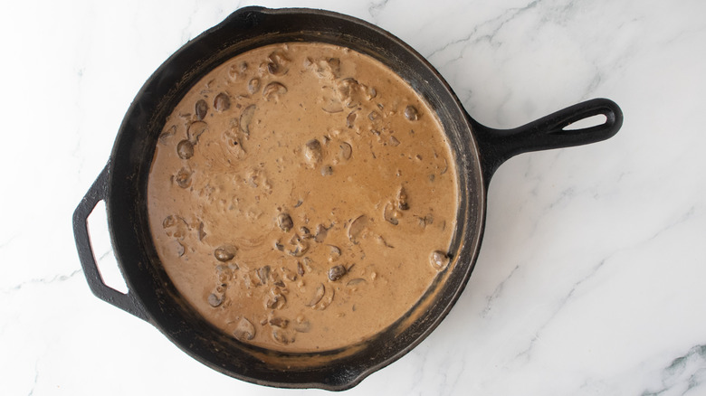 Light brown mushroom sauce in a large skillet