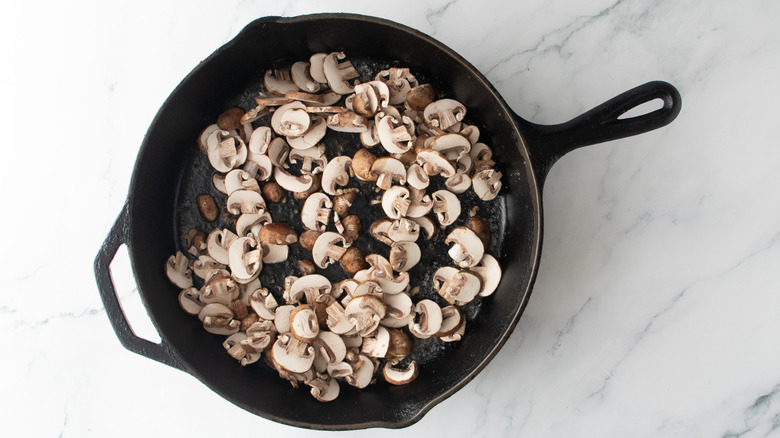Sliced mushrooms in a large skillet
