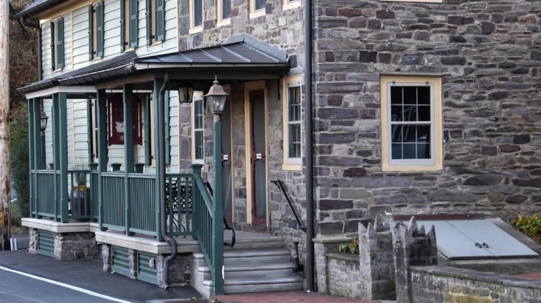 Exterior of the Lumberville General Store's stone building with a green porch