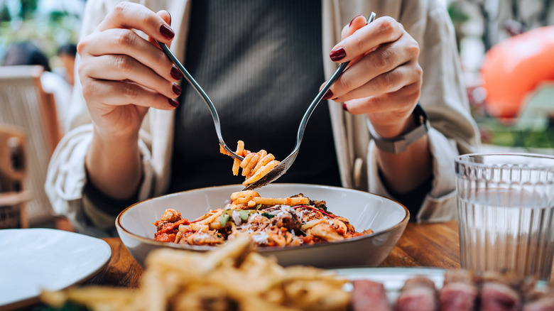 Diner eating pasta at a restuarant