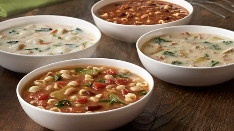 Each of Olive Garden's four soup choices in white bowls