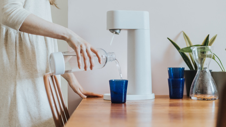 woman pouring sparkling water