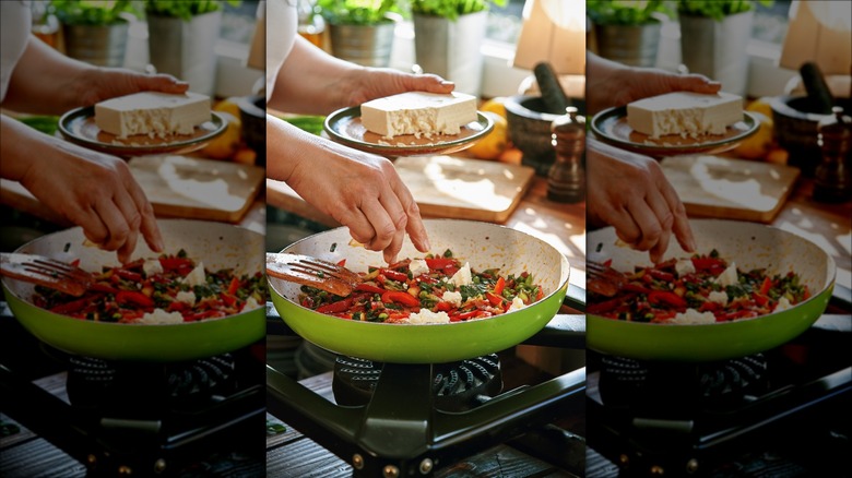 adding cheese to omelet pan