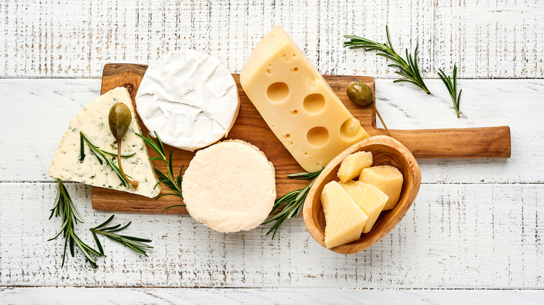 assortment of cheeses on board