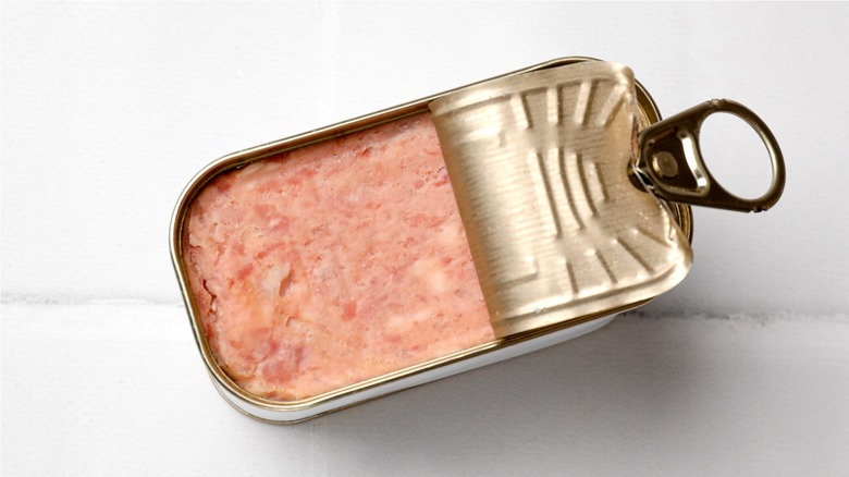 Tin of canned meat on a white background