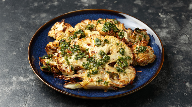 roasted cauliflower garnished with green herbs