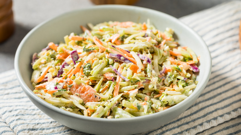 A white bowl of traditional coleslaw.