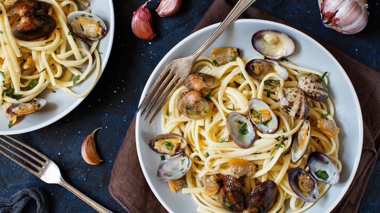 Pasta with clams on plates.