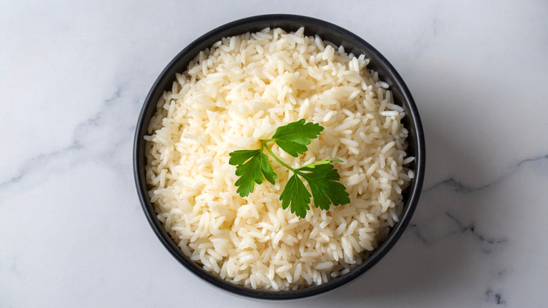 Cooked plain white rice is served in a bowl