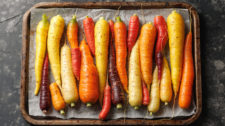 rainbow carrots ready to roast on a sheet pan