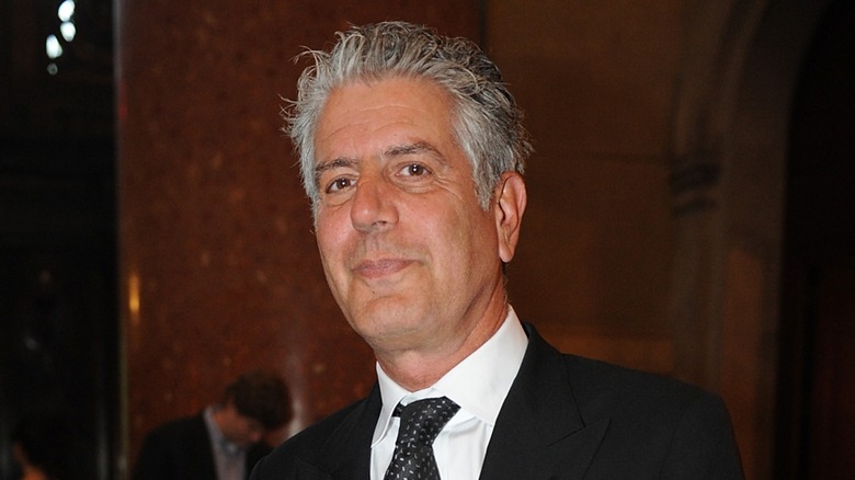 Photo of Anthony Bourdain in a suit smiling