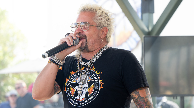 Guy Fieri speaking into a microphone