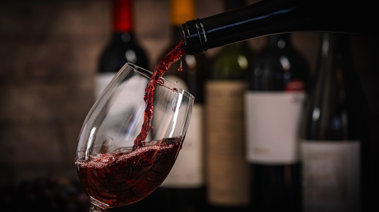 red wine being poured into a wine glass