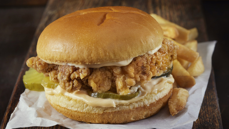A fried chicken sandwich with fries