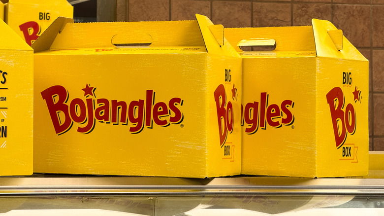 Two yellow Bojangles to-go containers