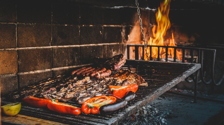 Meat and vegetables being cooked on the parrilla grill in Uruguay