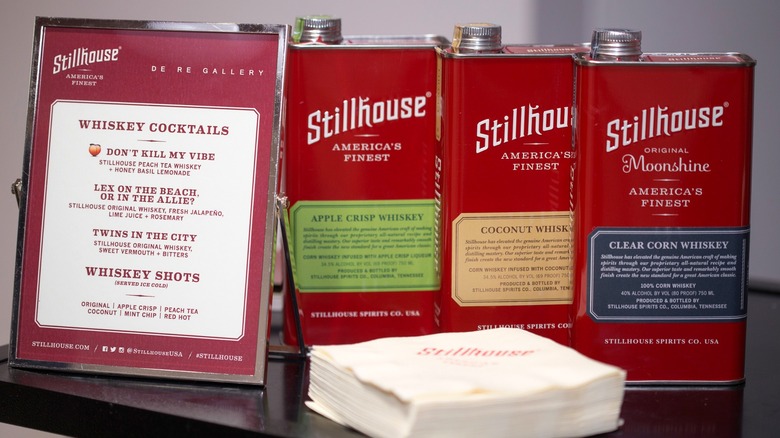 assorted cans of stillhouse whiskey with a cocktail menu