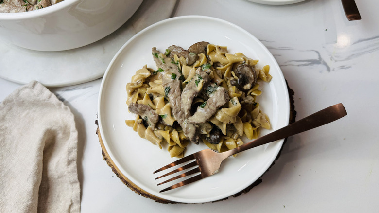 Beef stroganoff serving on plate with fork