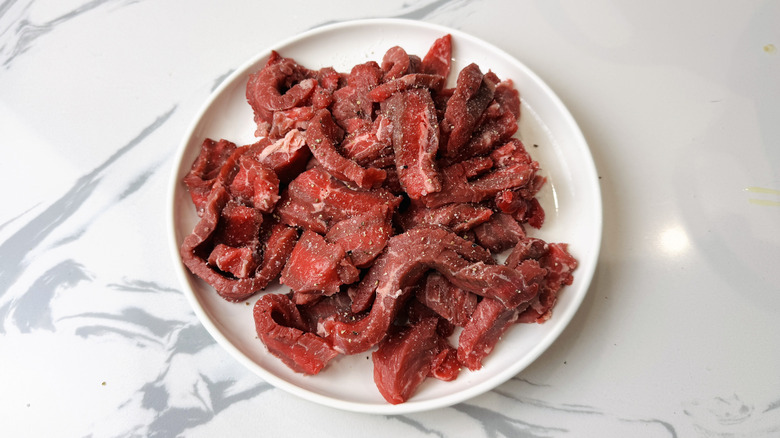 Seasoned beef strips on plate