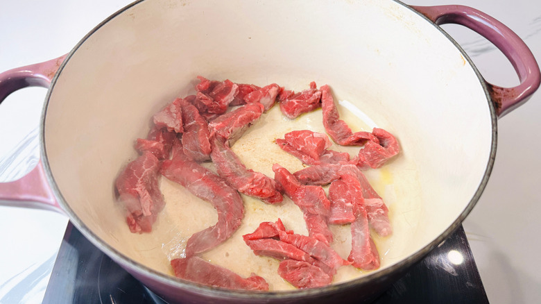 Beef strips cooking in Dutch oven