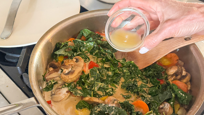 hand adding lime juice