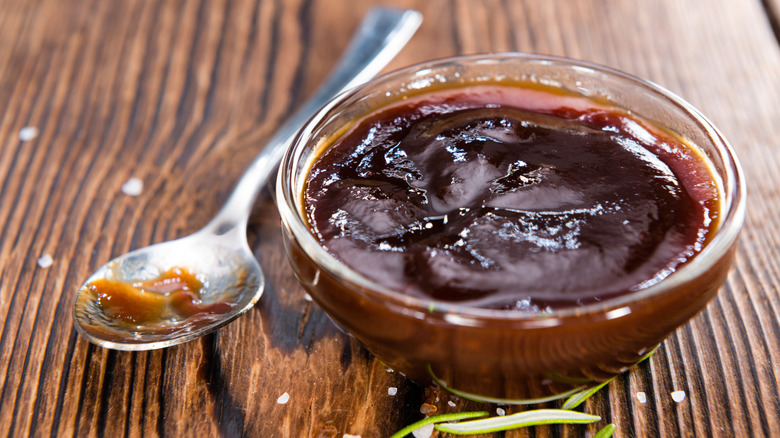close up of small dish of BBQ sauce with spoon