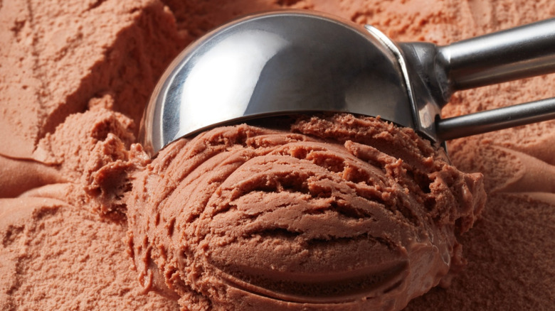 Chocolate ice cream being scooped.