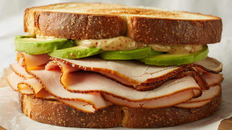 Turkey sandwich with avocado and mustard