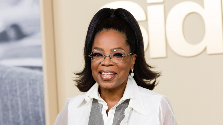 Oprah smiling and wearing glasses