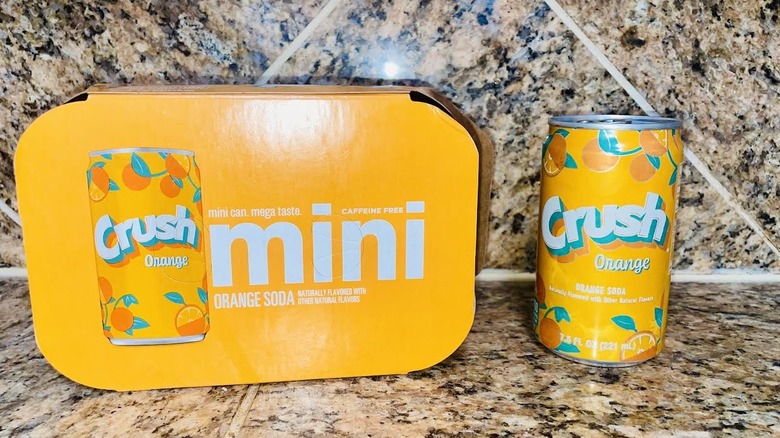 Box and can of Orange Crush soda on marble counter